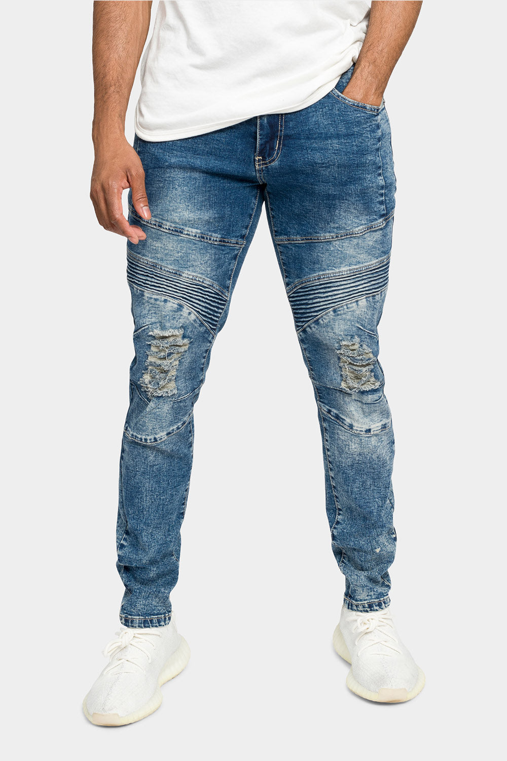 Faded indigo jeans stacking at the ankle